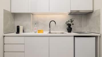 Apartment, 2 Bedrooms | Private kitchen | Coffee/tea maker, mini-fridge, stovetop, cookware/dishes/utensils