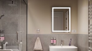 A modern bathroom with a shower, a sink, and a mirror. - Numa Milan Manfredo (Milan)