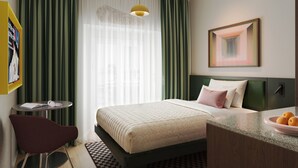A hotel room with a bed, a desk, a chair, a window with curtains, a hanging light, and a framed picture on the wall. - Numa Milan Manfredo (Milan)
