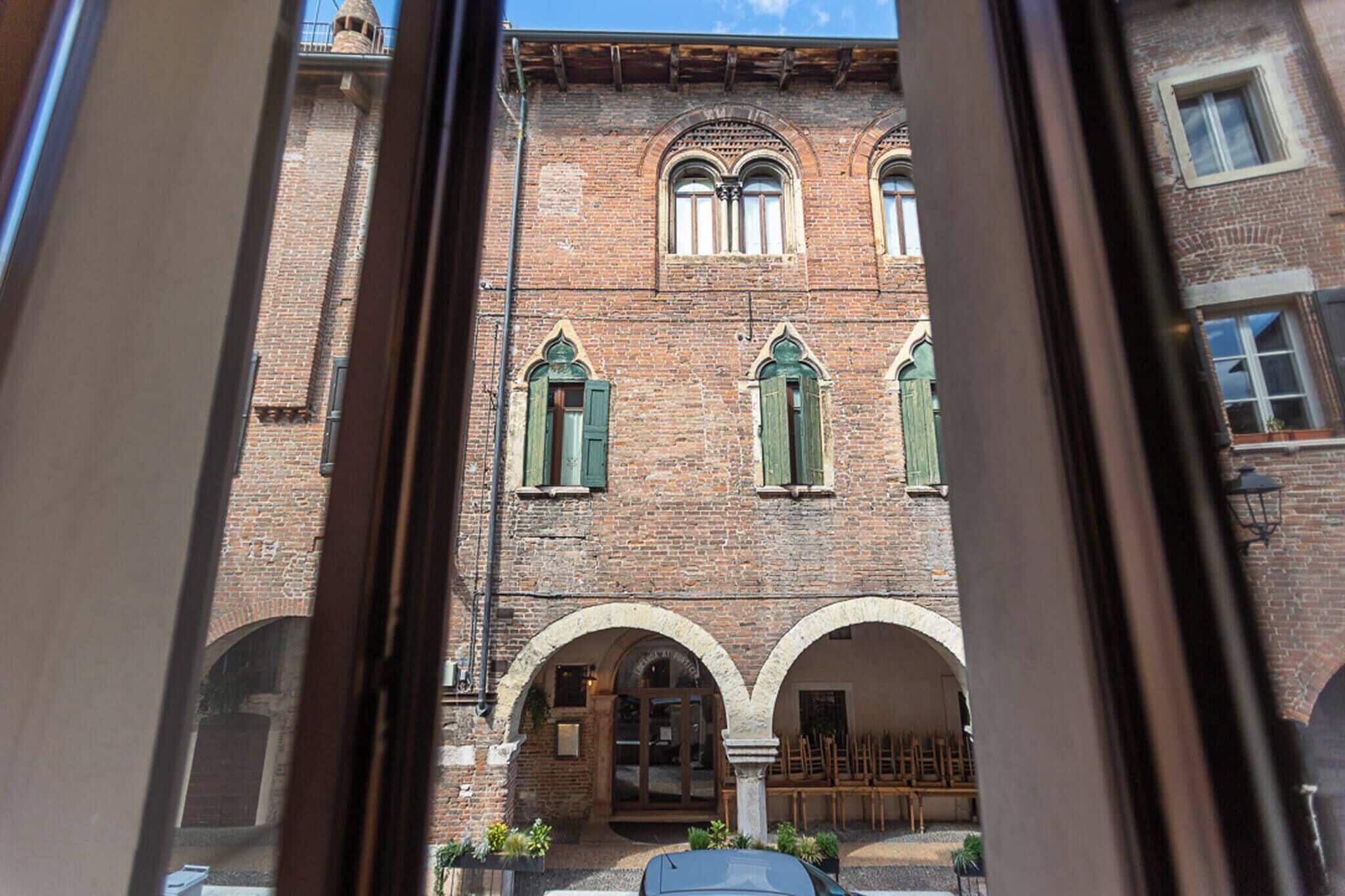 A brick building with arched windows and a central entrance.