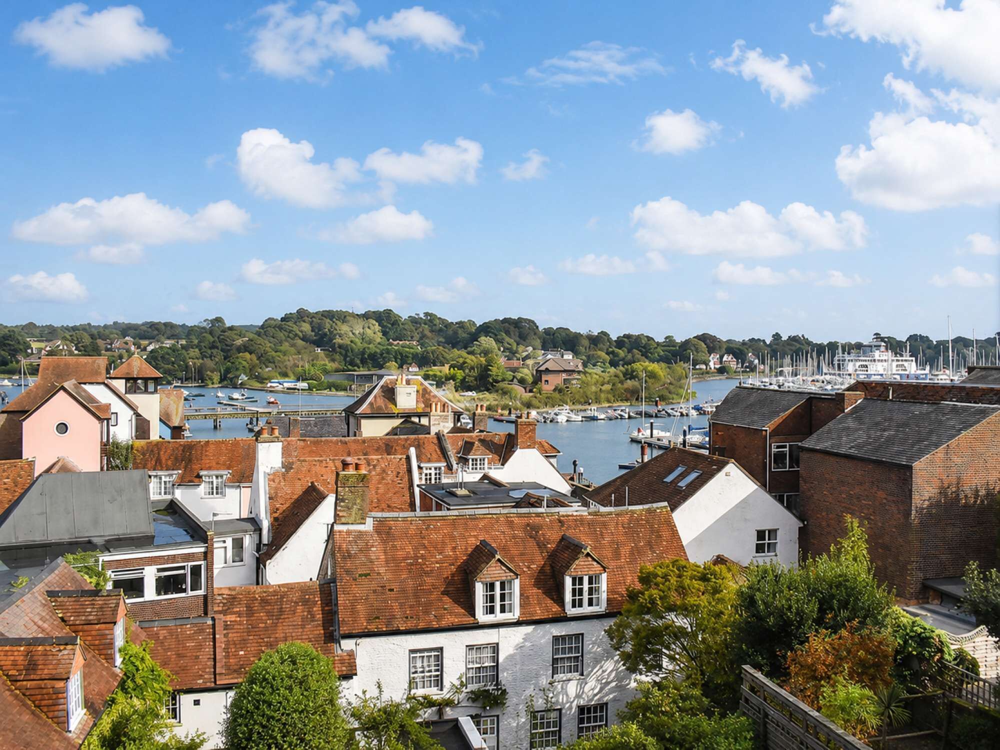A coastal town with traditional architecture, a marina, and a river.
