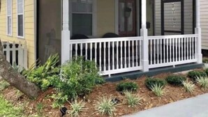 A yellow house with a porch and a screened area. - 3-bedroom house in charming Old Town Bay St. Louis (Bay St. Louis)