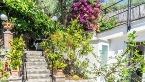 A stone staircase leading to a white building with a balcony. - Naos Nerano (Nerano)