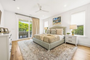 A bedroom with a bed, a nightstand, a window, and a ceiling fan. - Private Pool, Elevator, Close to Beach, New Construction, King Beds, SS0298 (Southern Shores)