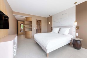 A modern bedroom with a large bed, a bedside table, a wardrobe, and a television mounted on the wall. - Somptuous 3-BR Penthouse - Pool & Ocean View - Saint-Tropez (Saint-Tropez)