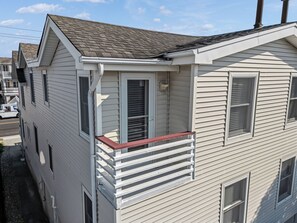 A two-story house with a visible front porch and a garage.