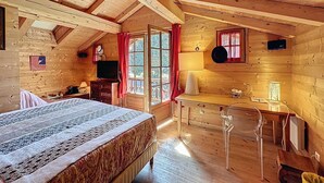 A cozy cabin with a bed, a desk, and a television. - The Red Room (Demi-Quartier)