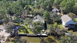 An aerial view of a residential area with houses, a dock, and a pond. - Amazing House on the Water in Timber Ridge (Pass Christian)
