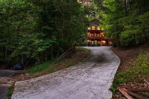 Un sendero que lleva a un edificio rodeado de un bosque frondoso.