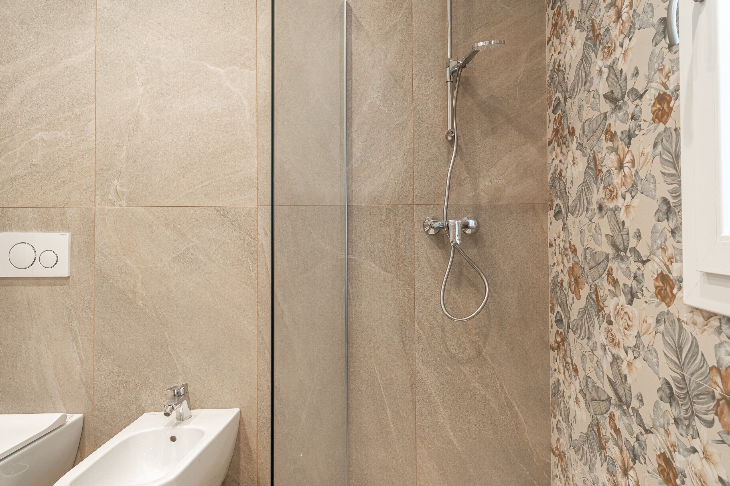 A bathroom with a shower, a sink, and a toilet.