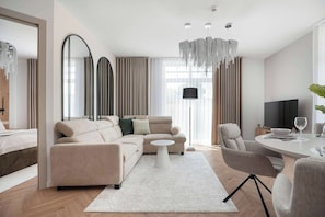 A modern living room with a sofa, coffee table, and dining area.