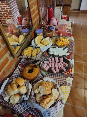 A buffet table with various food items and a mirror reflecting the room.