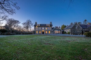 A large, two-story stone house with a well-maintained lawn in front. - Georgian Country House and Stable Sleeping 18 | Gorwel-Bryn-Hir (Criccieth)