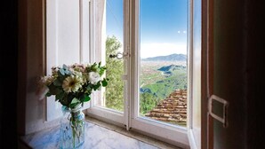 A window with a view of a mountainous landscape and a tiled roof. - Podere il Leccio with a Pool (LUCCA)