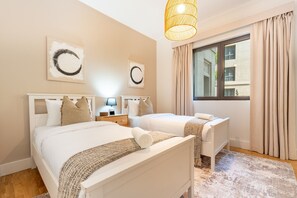 A hotel room with two beds, a large window with curtains, and artwork on the walls. - Spacious 2BR Haven, Within Easy Reach of Burj Khalifa and Dubai Mall (Dubai)