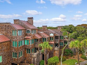 A multi-story building with a unique wooden exterior and multiple balconies.