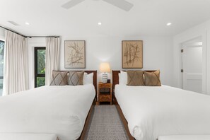 A hotel room with two beds, a nightstand with a lamp, and artwork on the walls. - 333 Victory Bay : 4  BR, 4.5  BA House in Kiawah Island , Sleeps 10 (Kiawah Island)