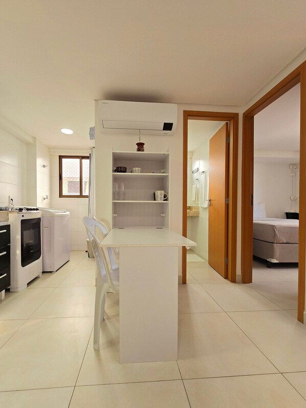 A modern kitchen with a central island, built-in appliances, and a dining area.