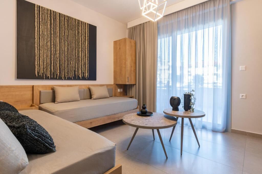 A modern living room with a sofa, a small round table, and a decorative wall piece.