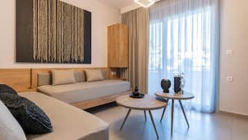 A modern living room with a sofa, a small round table, and a decorative wall piece.