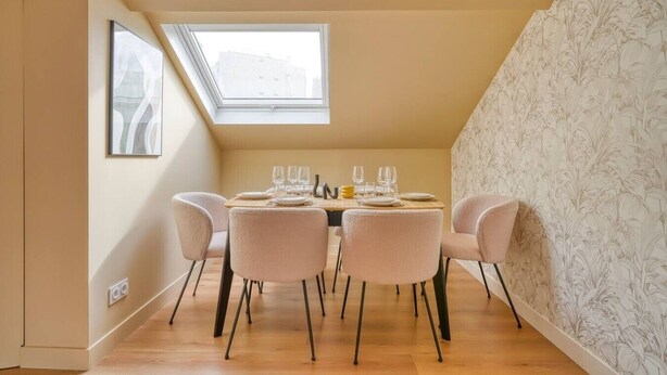 A dining area with a table set for four, a skylight, and patterned wallpaper. - 4G. 3-Bedroom Apartment for 6 People, Paris 15th Arrondissement, AC (Paris)
