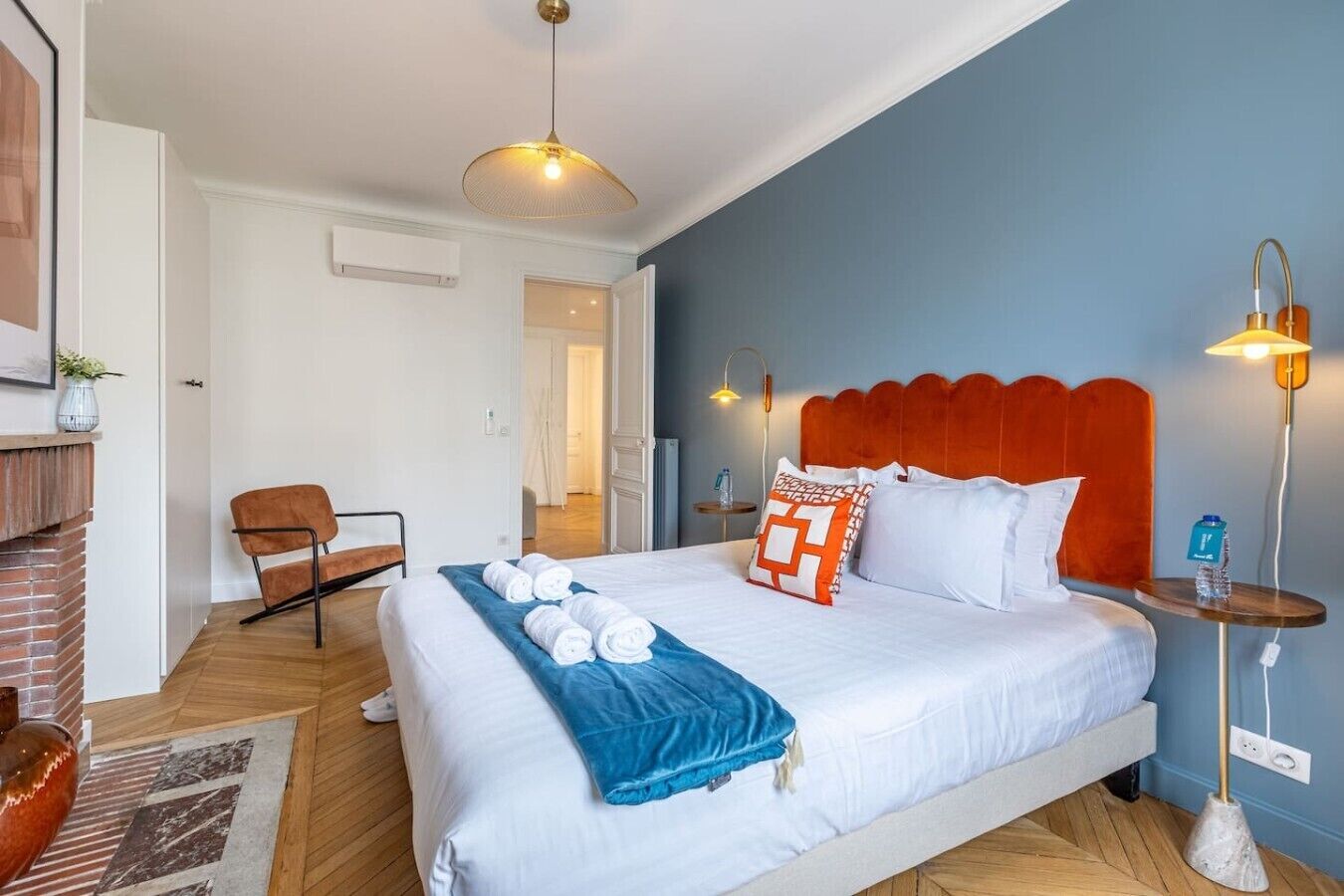 Een hotelkamer met een bed, een stoel, een tafel en een lamp.