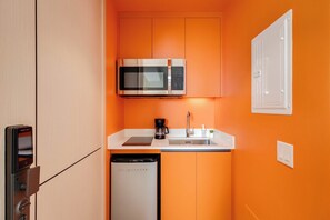 A compact kitchen with a microwave, coffee maker, and dishwasher. - 305 Cook - Loft in the Heart of Old Quebec (Québec)
