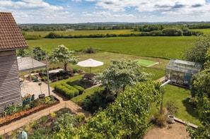 A residential property with a well-maintained garden, a patio area, and a greenhouse. - Outstanding contemporary country house, close to Bath with stunning views. (Bath)
