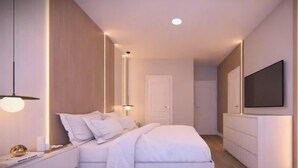 Een moderne slaapkamer met een bed, nachtkastje, televisie en een garderobe.