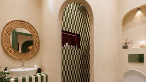 A bathroom with a checkered floor, a sink with a mirror, and a toilet. - StayHere Essaouira Heritage – Dar El Qadima (Essaouira)