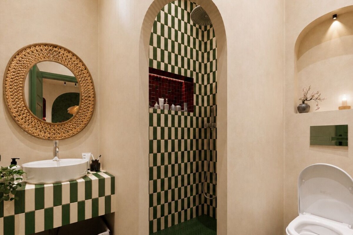 A bathroom with a checkered floor, a sink with a mirror, and a toilet.