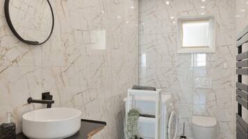 Ein Badezimmer mit Waschbecken, Toilette und Spiegel.