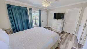 A bedroom with a bed, a ceiling fan, a television, and a wardrobe. - Spacious + In A Great Location Sandprints B1 (Miramar Beach)