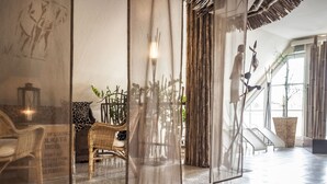 A modern interior with a seating area, a staircase, and a large window. - Explore Lakes & Forests | Single Room | Sauna & Dining Experience (Sundern (Sauerland))