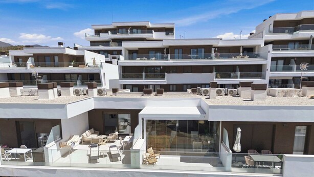 A multi-story residential building with balconies, outdoor seating areas, and a pool. - Rooftop* Terrace*pool*parking* Town view (Estepona)