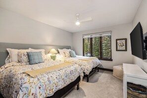 A bedroom with a bed, bedside tables, a ceiling fan, a window with a view of trees, and a framed picture on the wall. -  REMODELED 2 BEDROOM CONDO  PINECONE IN ARROWHEAD CLOSE TO LIFT (Edwards)