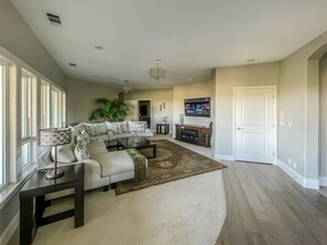 A spacious living room with a sofa set, a coffee table, a rug, and a television. - Serrano Village Villa - El Dorado Hills (El Dorado Hills)
