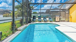 A swimming pool with a glass enclosure, lounge chairs, and a barbecue area. - 4 BDR South-Facing Disney Retreat (Kissimmee)