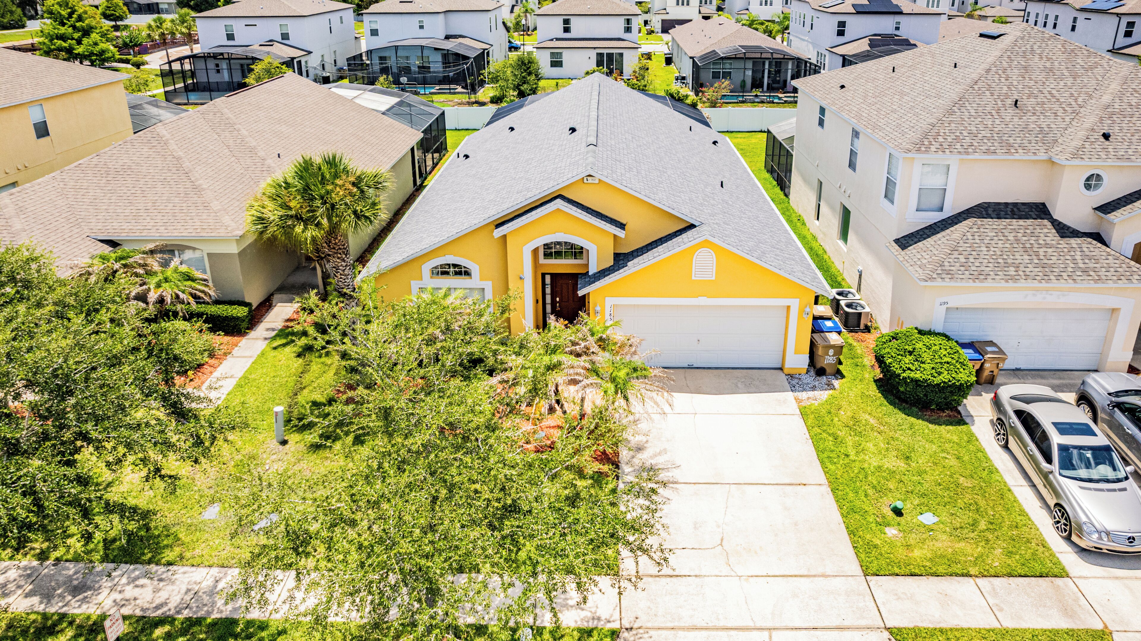 A residential area with houses, a driveway, and a garage.