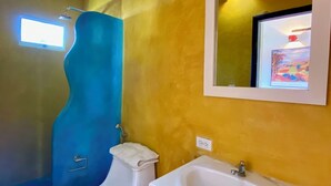 A bathroom with a toilet, sink, and shower. - Italcaribe Village (Paraguachí)