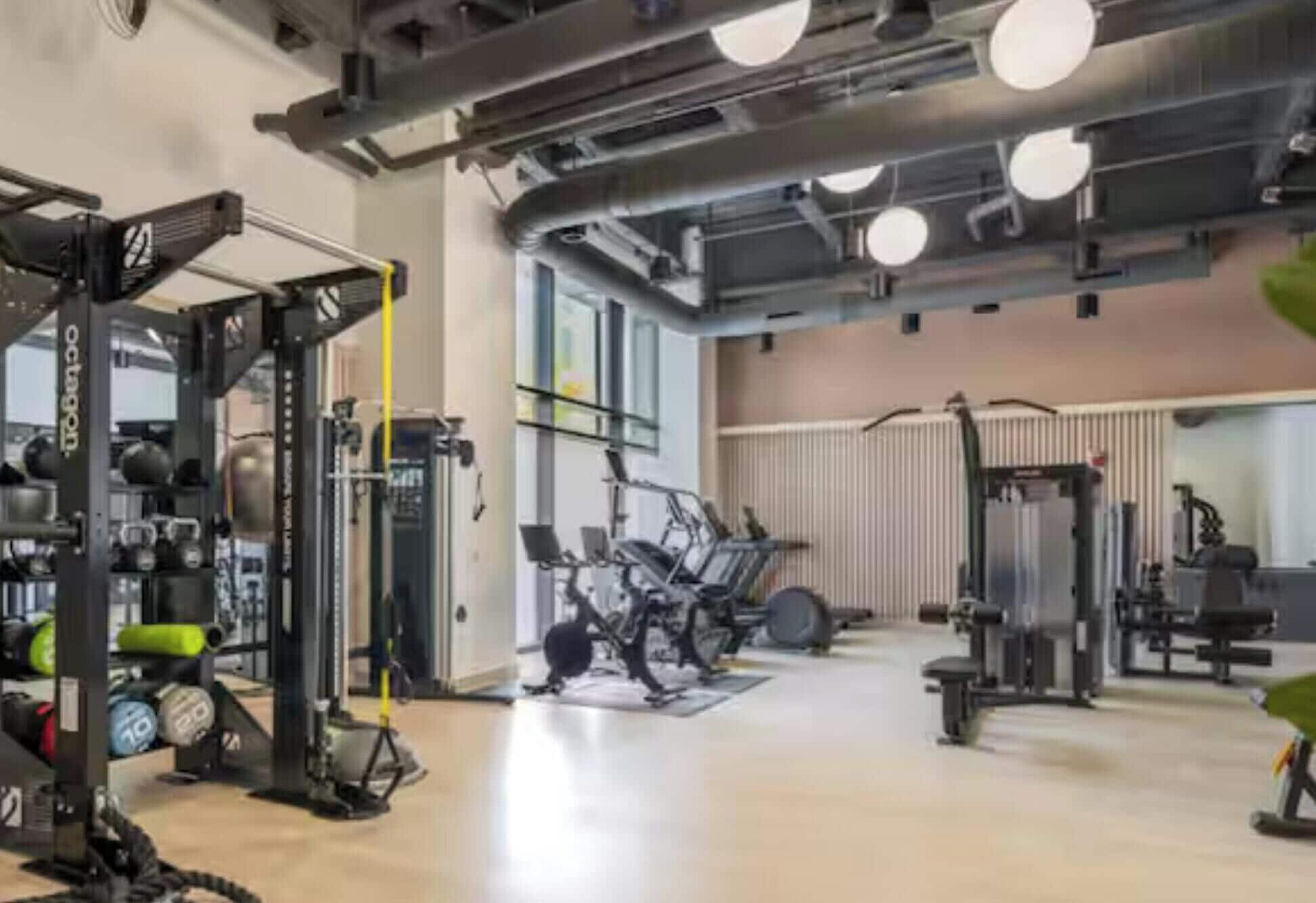 A gym with various exercise equipment, including weight machines and cardio machines.