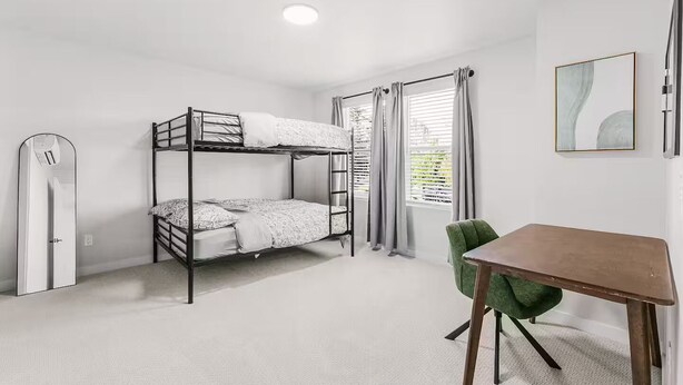 A bunk bed room with a desk and chair, a radiator, and a window with curtains. - Evergreen Home - King Bed · Office Room · Near PDX (Gresham)