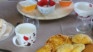 A breakfast setting with a variety of food items and beverages on a table. - “Cézallier Room” Guest Suite with Private Terrace and Jacuzzi (Soulages)