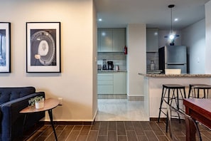 A modern apartment with a living room, a kitchen, and a dining area. - Group Friendly | Private Terrace & BBQ in Roma Sur (Mexico City)