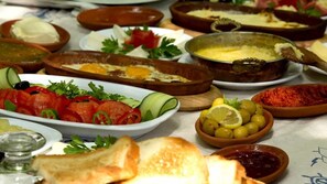 A variety of dishes including bread, salad, and a bowl of olives. - ÇANKAYA SUIT (Çankaya)