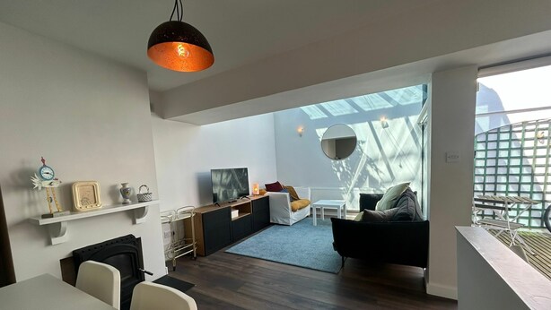 A modern interior with a dining area, kitchen, and seating space. - 2BDR 2BA Upside Down House with Sunny Balcony (Dublin)