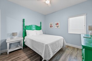 A bedroom with a bed, a nightstand, a dresser, and a window with blinds. - Lighthouse 1414 - Owner Managed, Fully Updated. Beautiful 3BR Gulf Front Condo. (Gulf Shores)