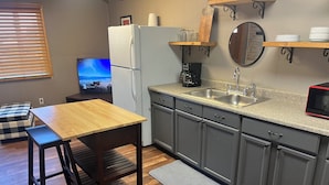 A compact kitchen with a refrigerator, double sink, and a microwave. - Le Maison Bruin  (Cortez)