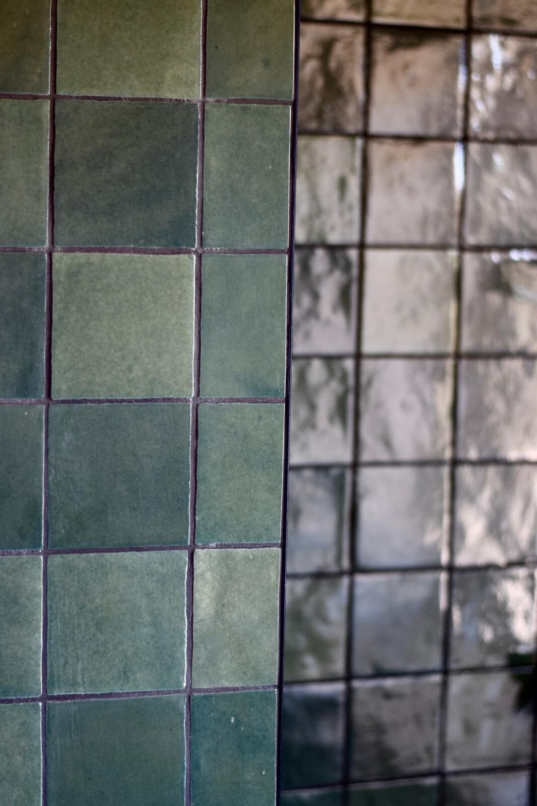 A section of a tiled wall with a grid pattern.