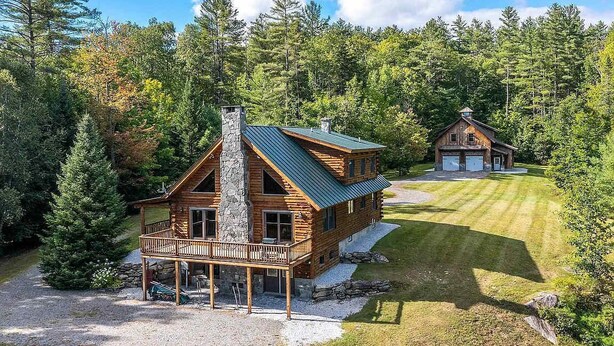 A cabin with a stone chimney, wooden exterior, and a deck. - Log Cabin Retreat on Private Vermont Estate (Reading)